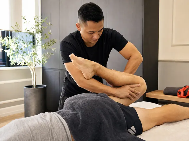 Therapist mobilising a runner's leg during a targeted sports massage session